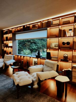 A cosy well lit home with a window looking out onto greenery