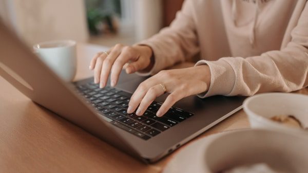 Woman typing on a laptop at a desk