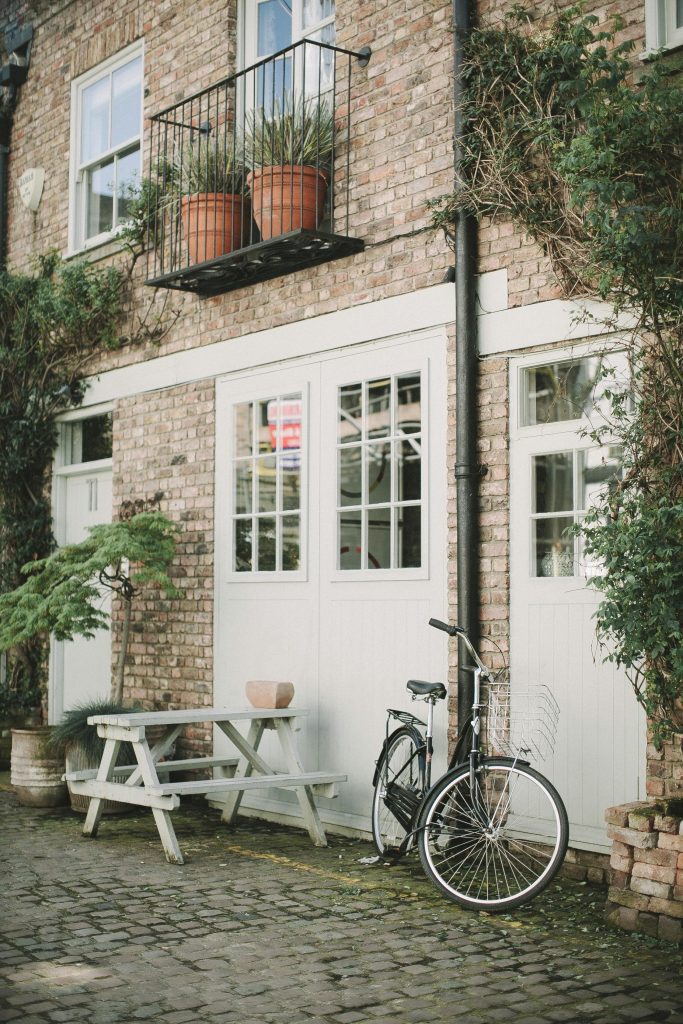 Terrace house with a small bench and bike outside