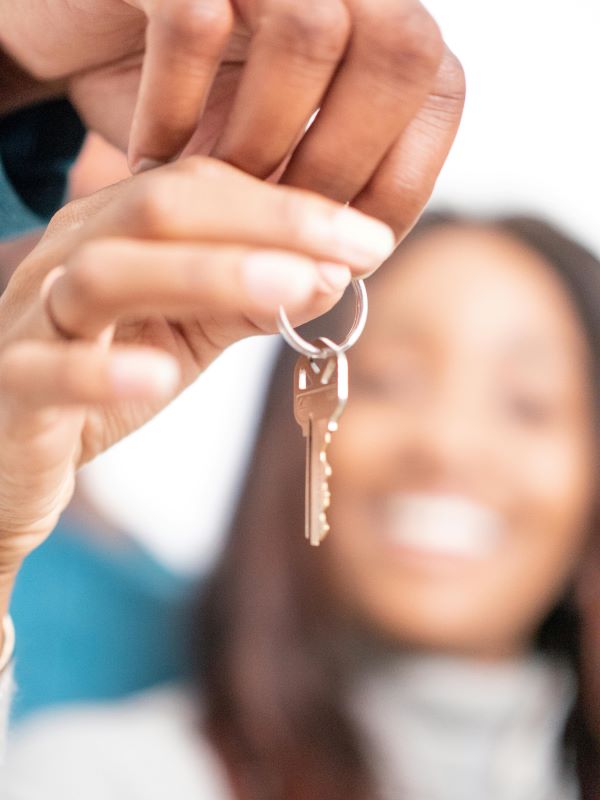 Couple showing off the key to their new shared ownership home