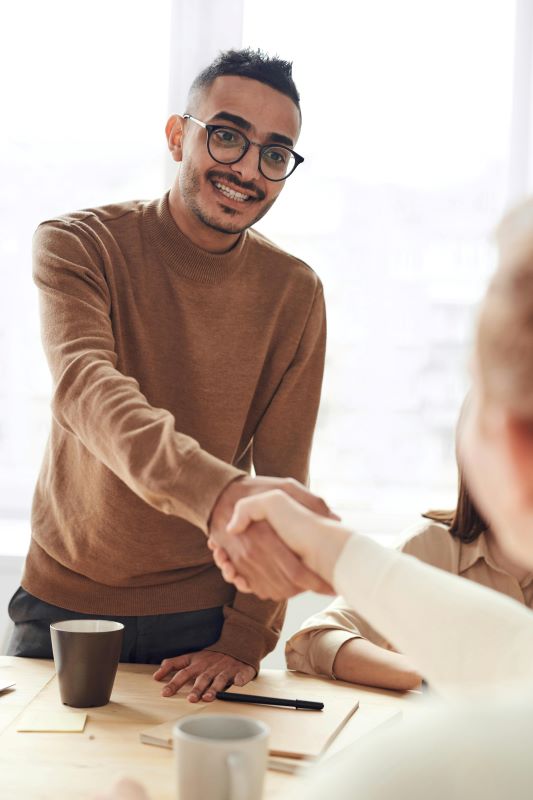 Person shaking hands after remortgaging their shared ownership property